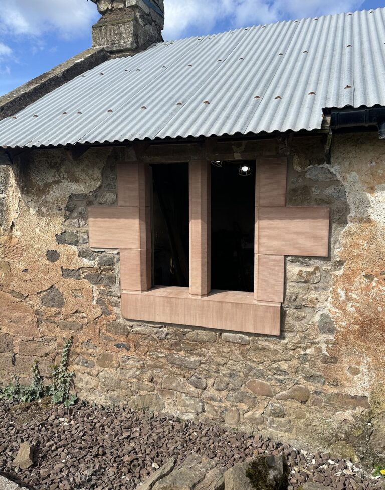Restored stone outbuilding with new sandstone window surrounds at West Lodge
