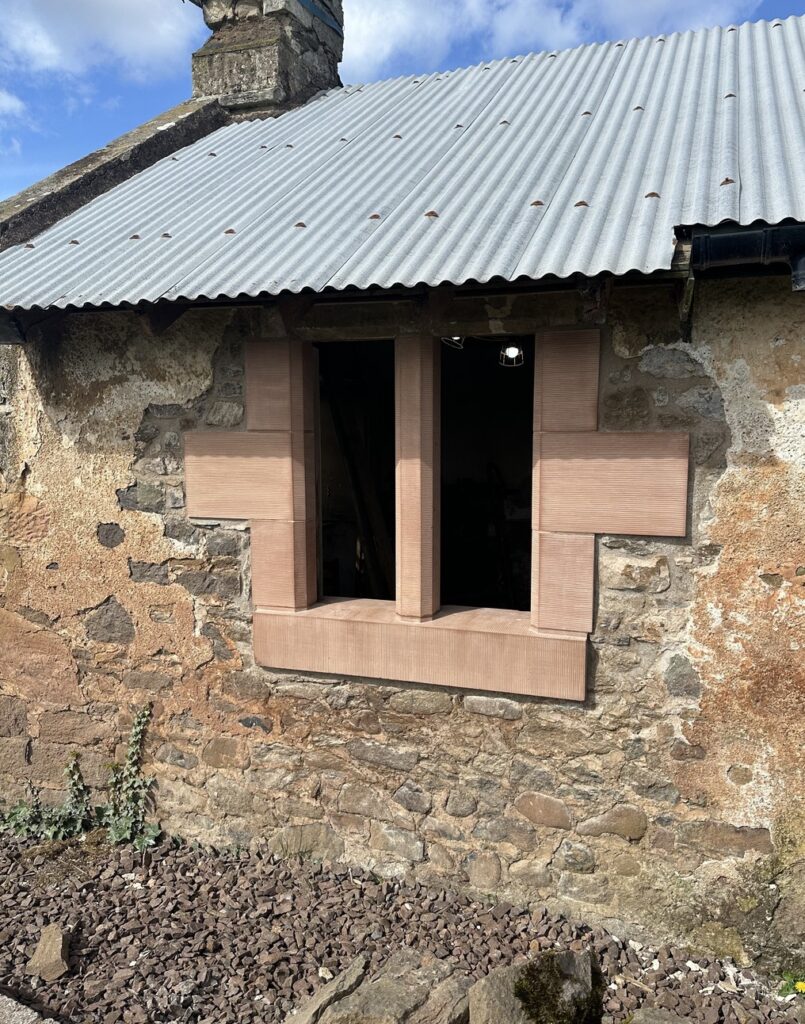 Restored stone outbuilding with new sandstone window surrounds at West Lodge