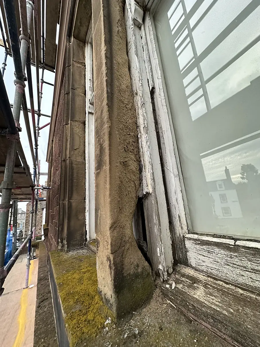 Weathered sandstone window jamb and sill before repair at The Square