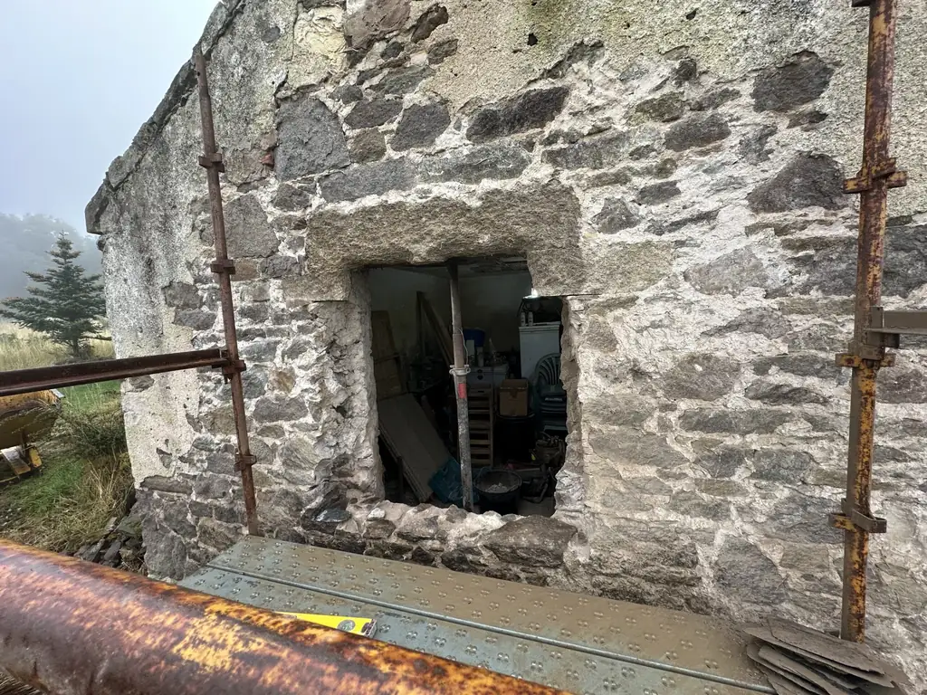 Window opening in a rubble stone wall before restoration at West Lodge