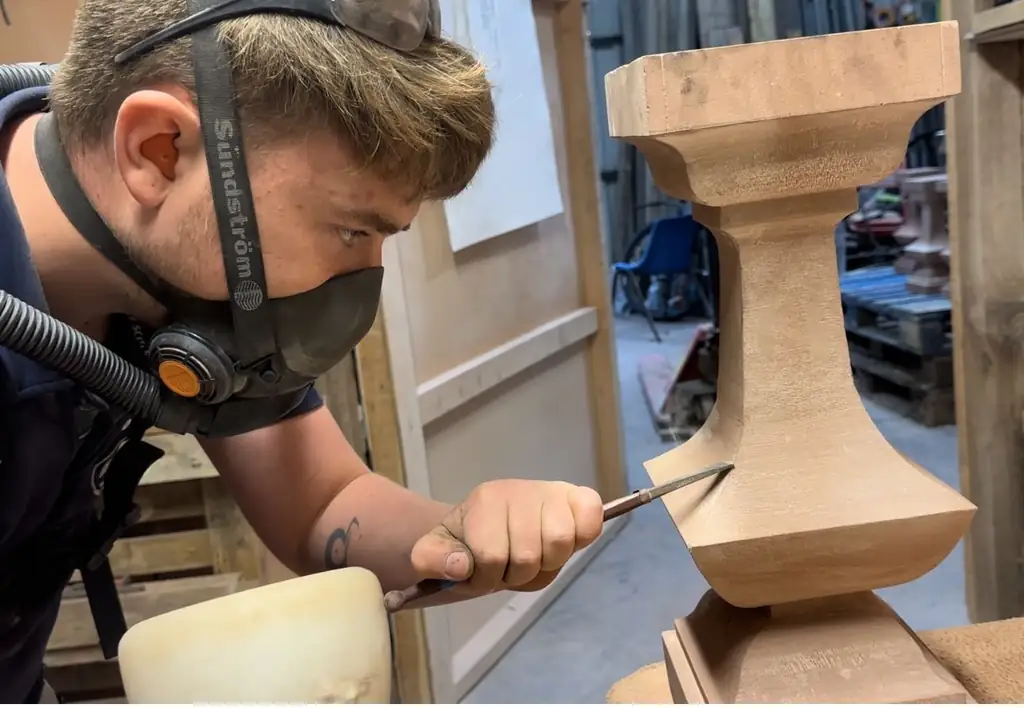 Stonemason carving stone in the R. French Stonemasonry workshop